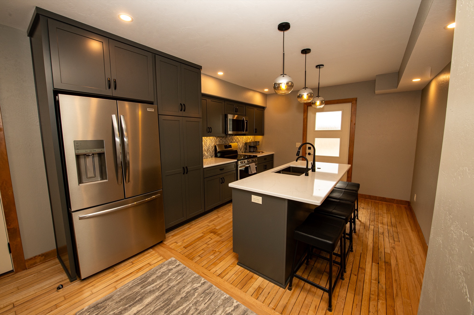 Modern kitchen with stainless steel appliances and quartz-topped island