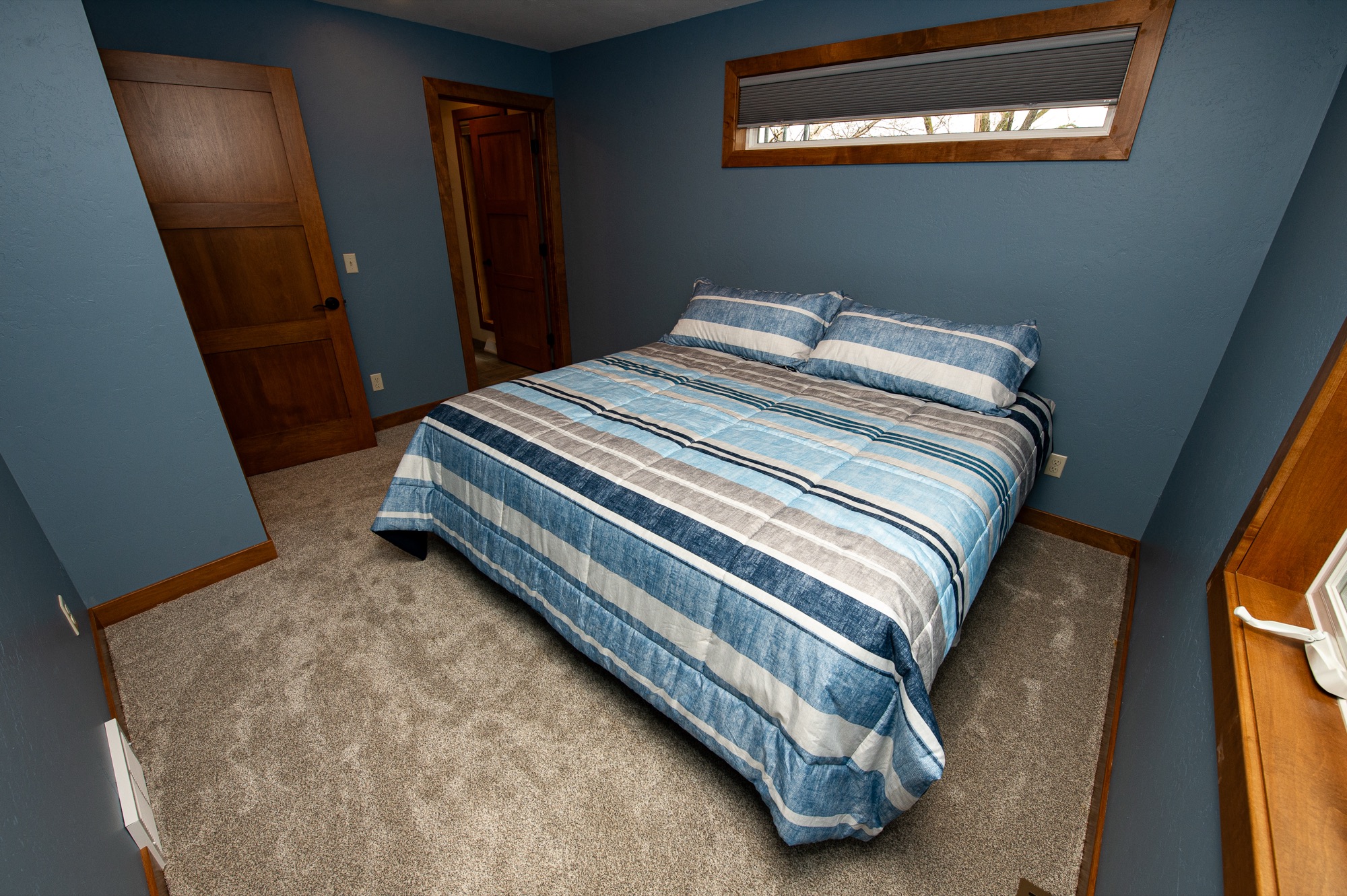Bedroom with king bed and warm blue walls
