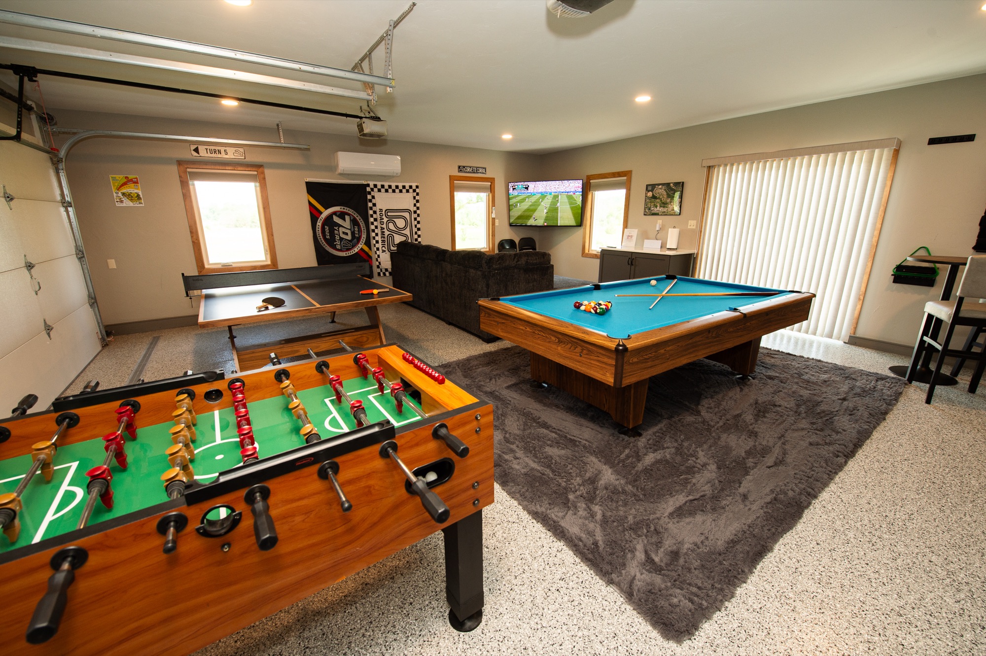Game room with foosball table, ping-pong table, and full-size pool table